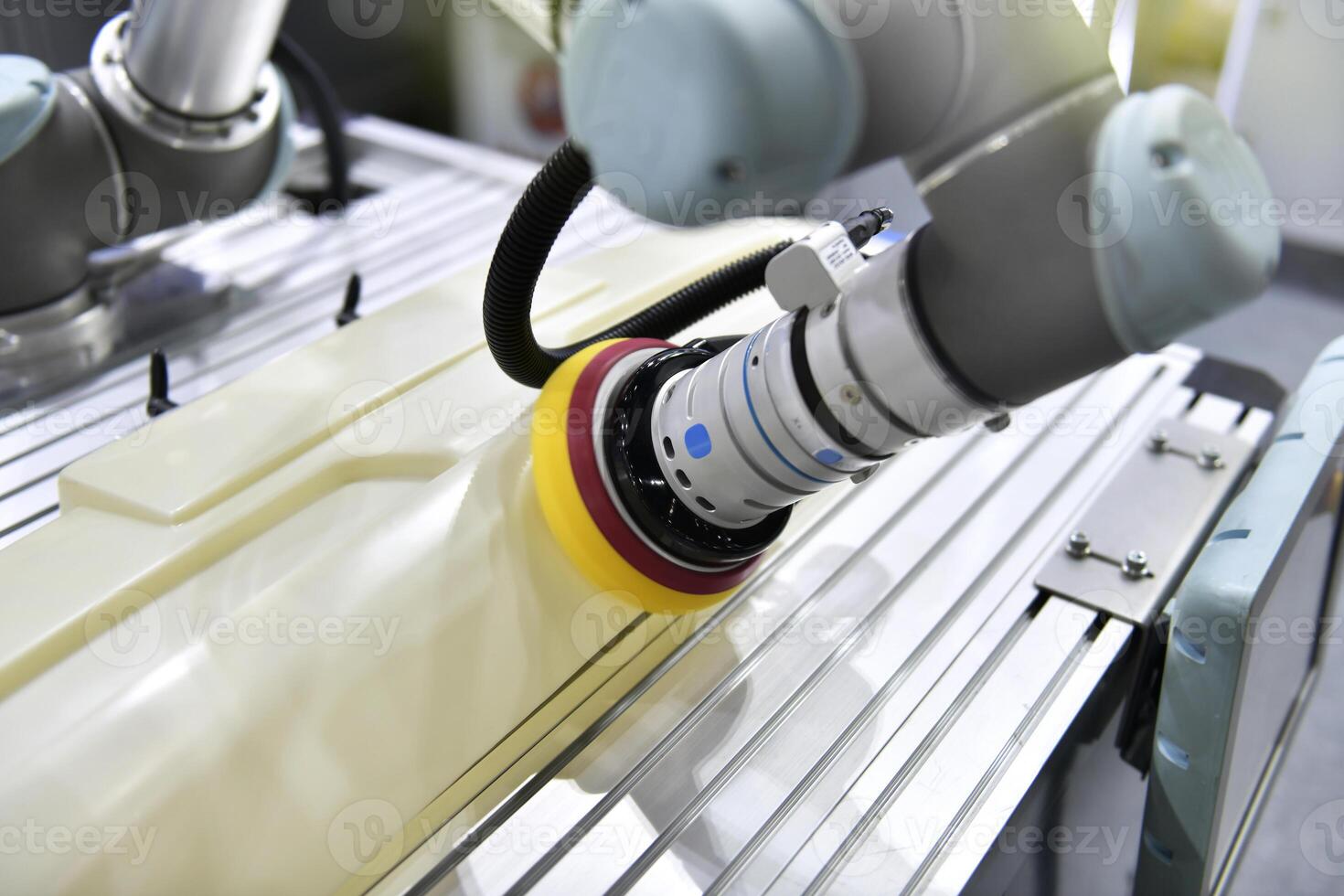 Robotic arm polishing the automotive car part in the production line. photo