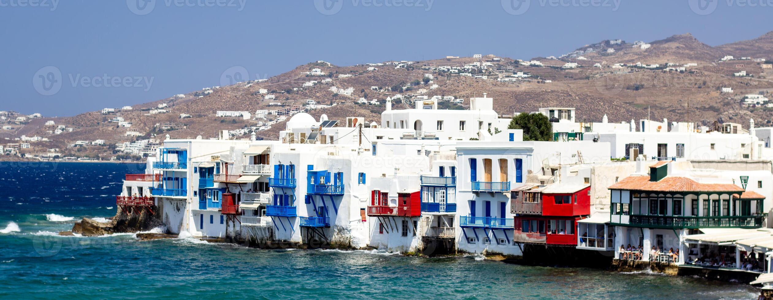View of traditional greek village with white houses on Mykonos Island, Greece photo
