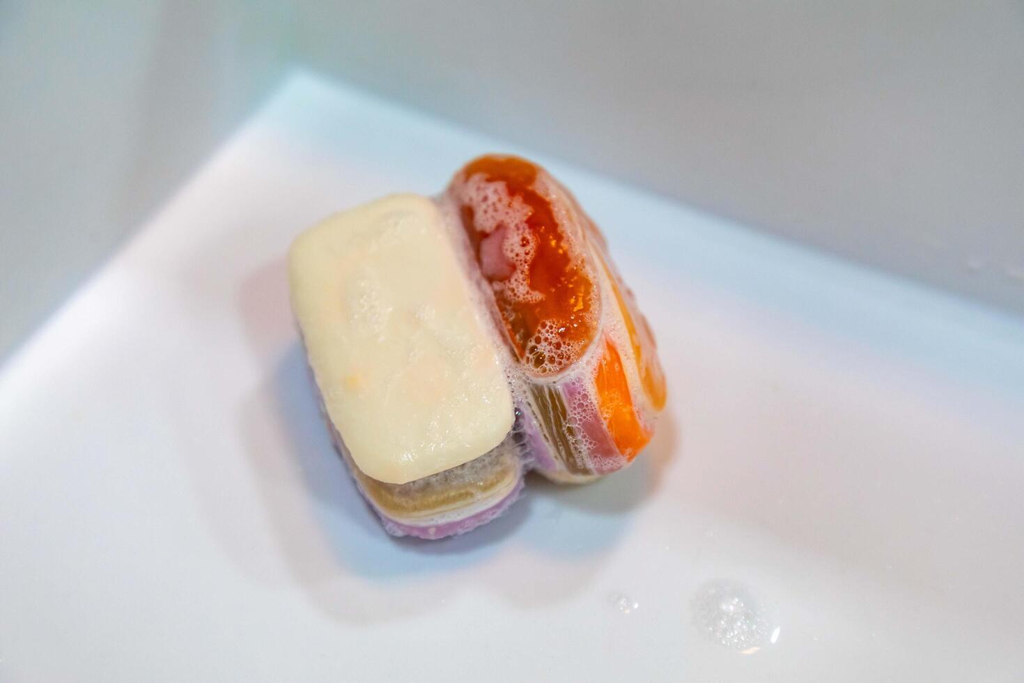 Used soaps glued together to form a ball. Ball of Used Soaps of different colors. economy and use photo