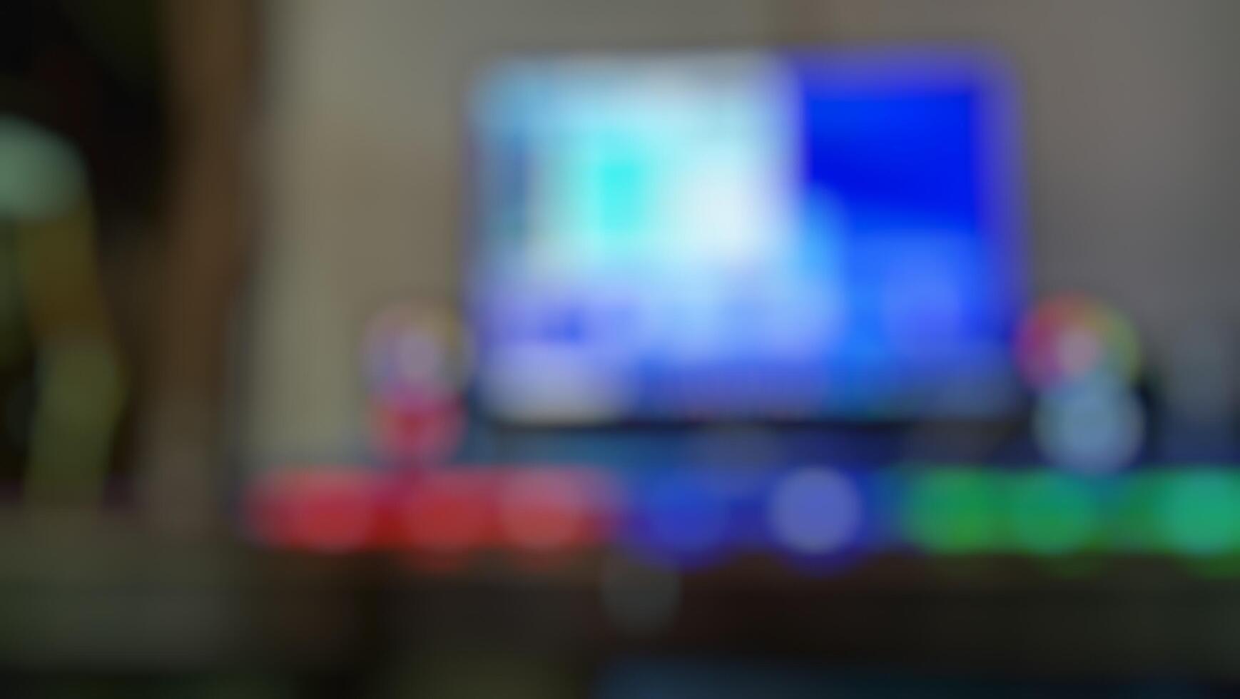 Blurred image of a computer screen and gaming setup photo