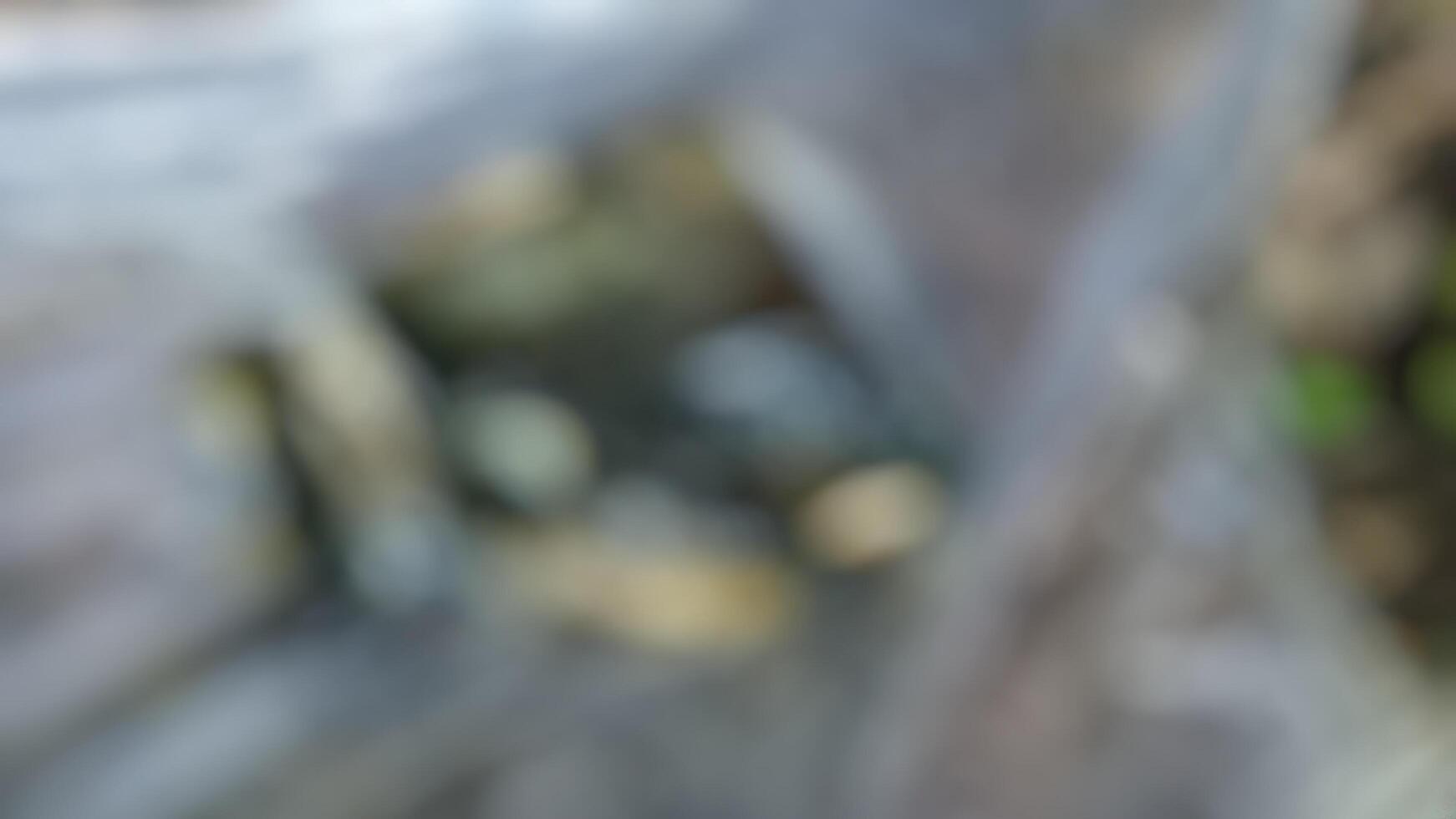 Abstract blurred background of rocks and water, suggesting a serene natural environment. Ideal for websites, presentations, or design projects needing a calming, natural feel. photo