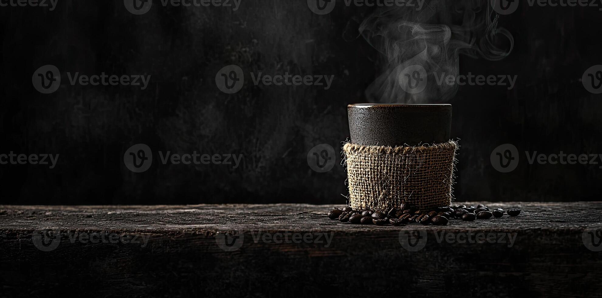 Coffee cup with steam and coffee beans on a wooden background. A cup of hot espresso or black latte, with a burlap sack on an old, rustic table photo