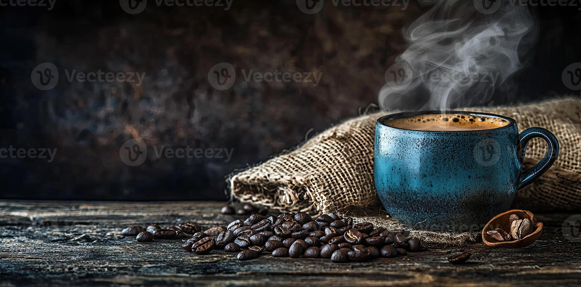 Coffee cup with steam and coffee beans on a wooden background. A cup of hot espresso or black latte, with a burlap sack on an old, rustic table photo