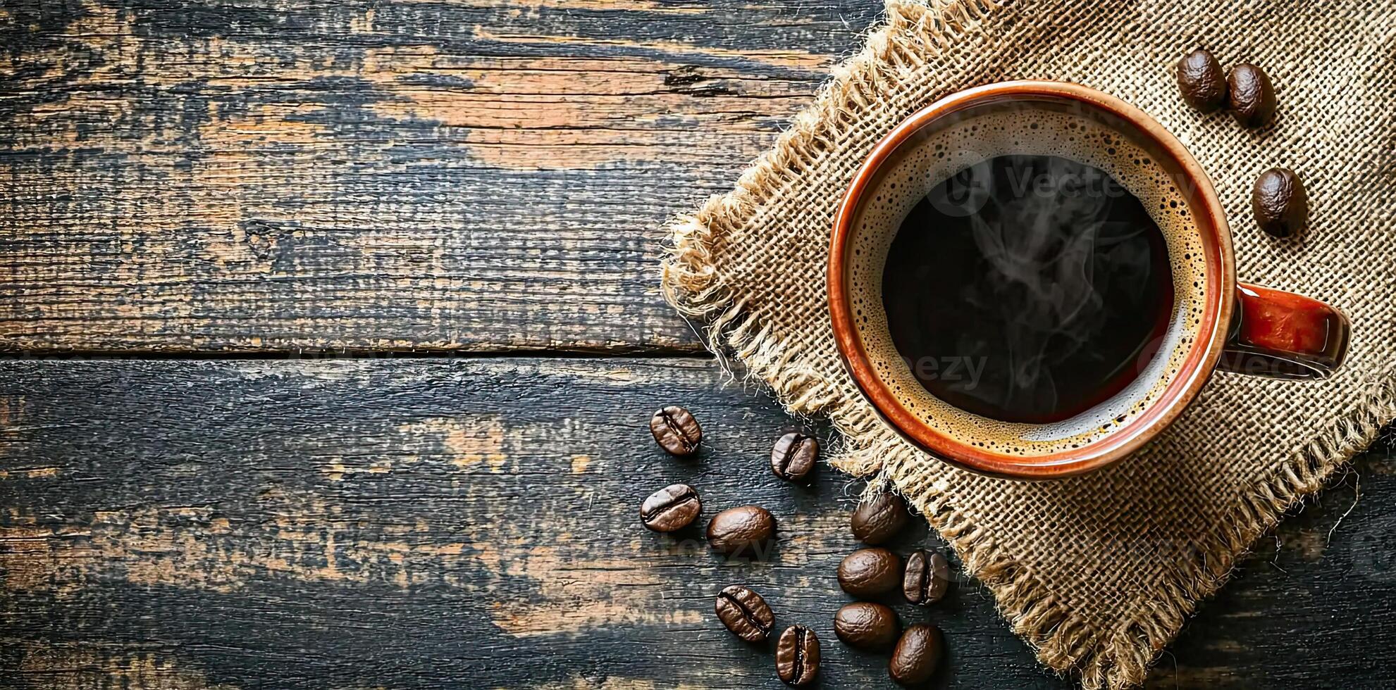 Coffee cup with steam and coffee beans on a wooden background. A cup of hot espresso or black latte, with a burlap sack on an old, rustic table photo
