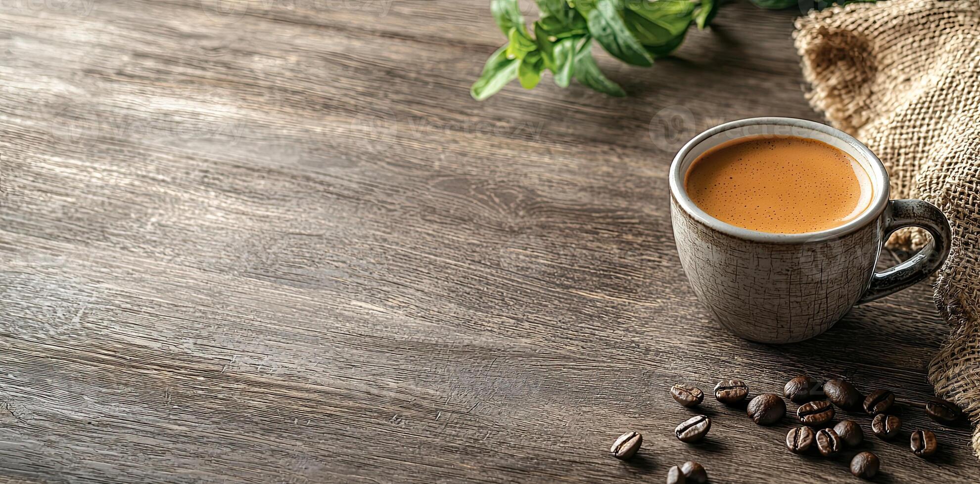 Coffee cup with steam and coffee beans on a wooden background. A cup of hot espresso or black latte, with a burlap sack on an old, rustic table photo