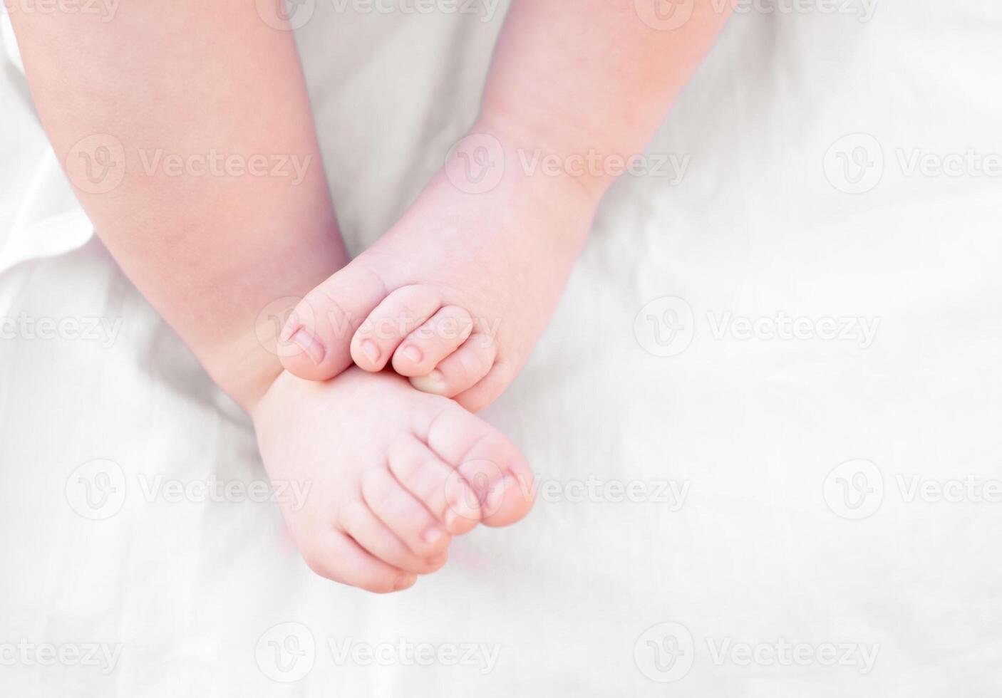 Legs close-up of newborn baby on light background photo