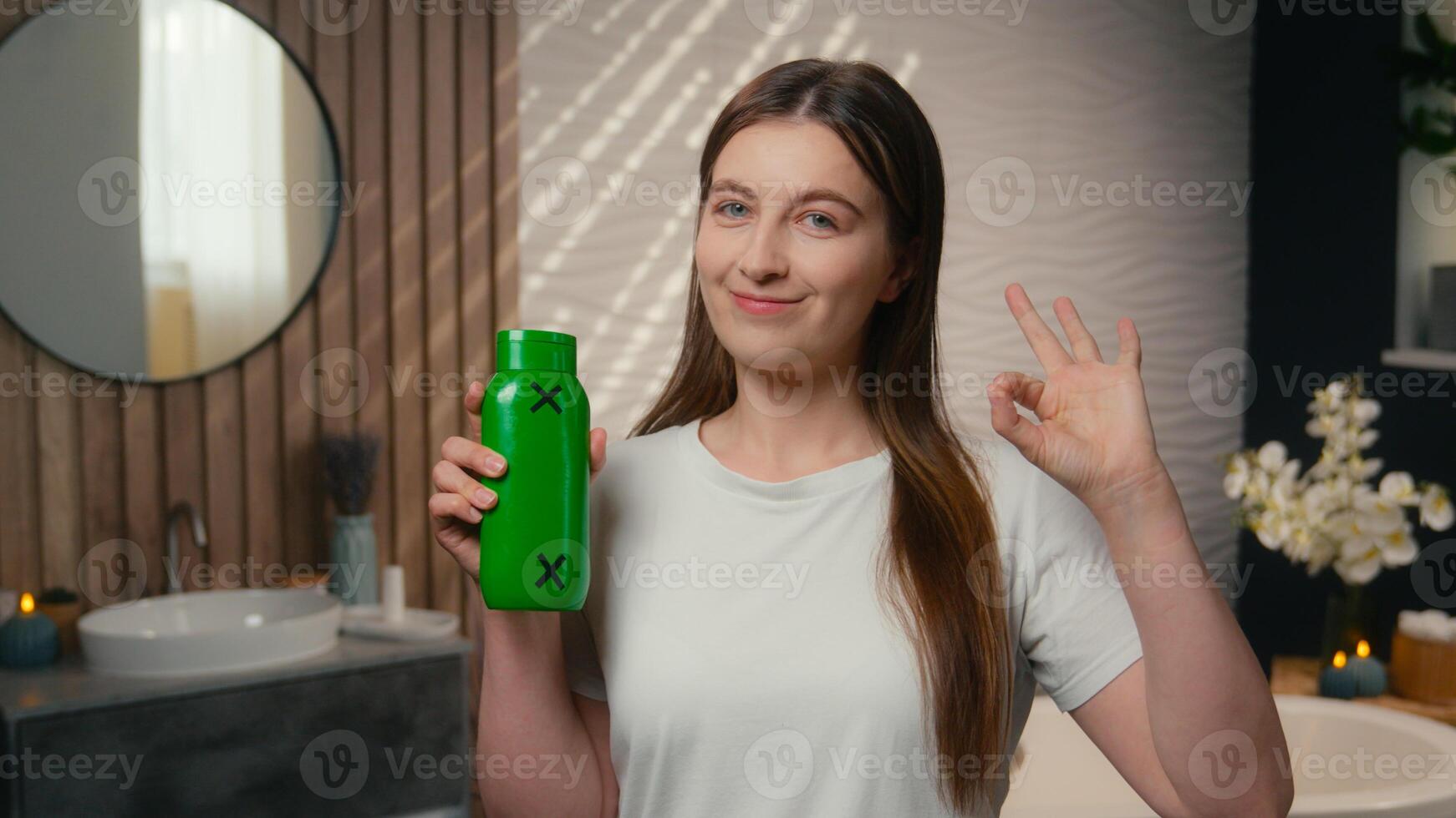 Beautiful smiling woman happy Caucasian girl European lady female in home bathroom showing bottle shampoo shower gel balm conditioner washing hair natural luxury cosmetics hairstyle care beauty spa photo