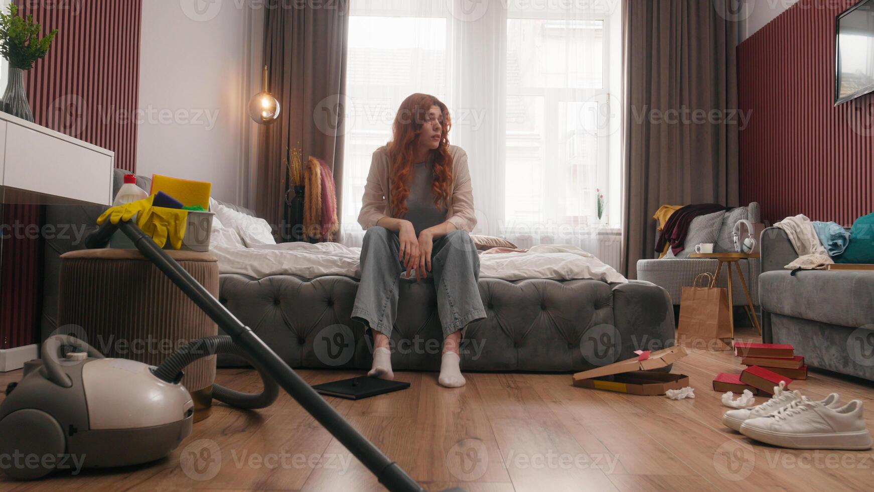 Exhausted sad upset Caucasian woman girl female homeowner lady housewife tired headache stress anxious frustrated mess in bedroom cleaning home chore problem trouble messy dirty housekeeping cleanup photo