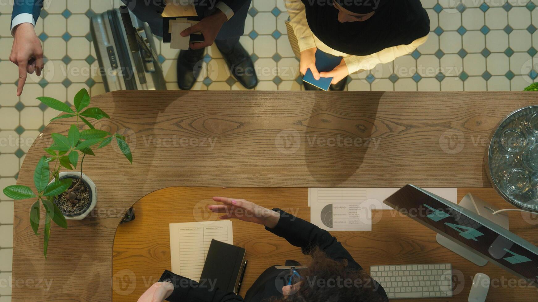Top view concierge meet guests welcome hotel reception muslim couple tourists travelers arrive resort journey vacation travel abroad administrator check passports give key card booking room service photo
