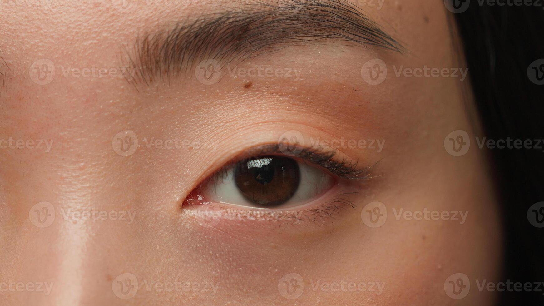 Extreme close up female dark eyes details Asian woman girl korean chinese ethnic healthy japanese lady eyesight human eye opening iris eyeball blink eyelash gaze vision beauty face skincare cosmetics photo