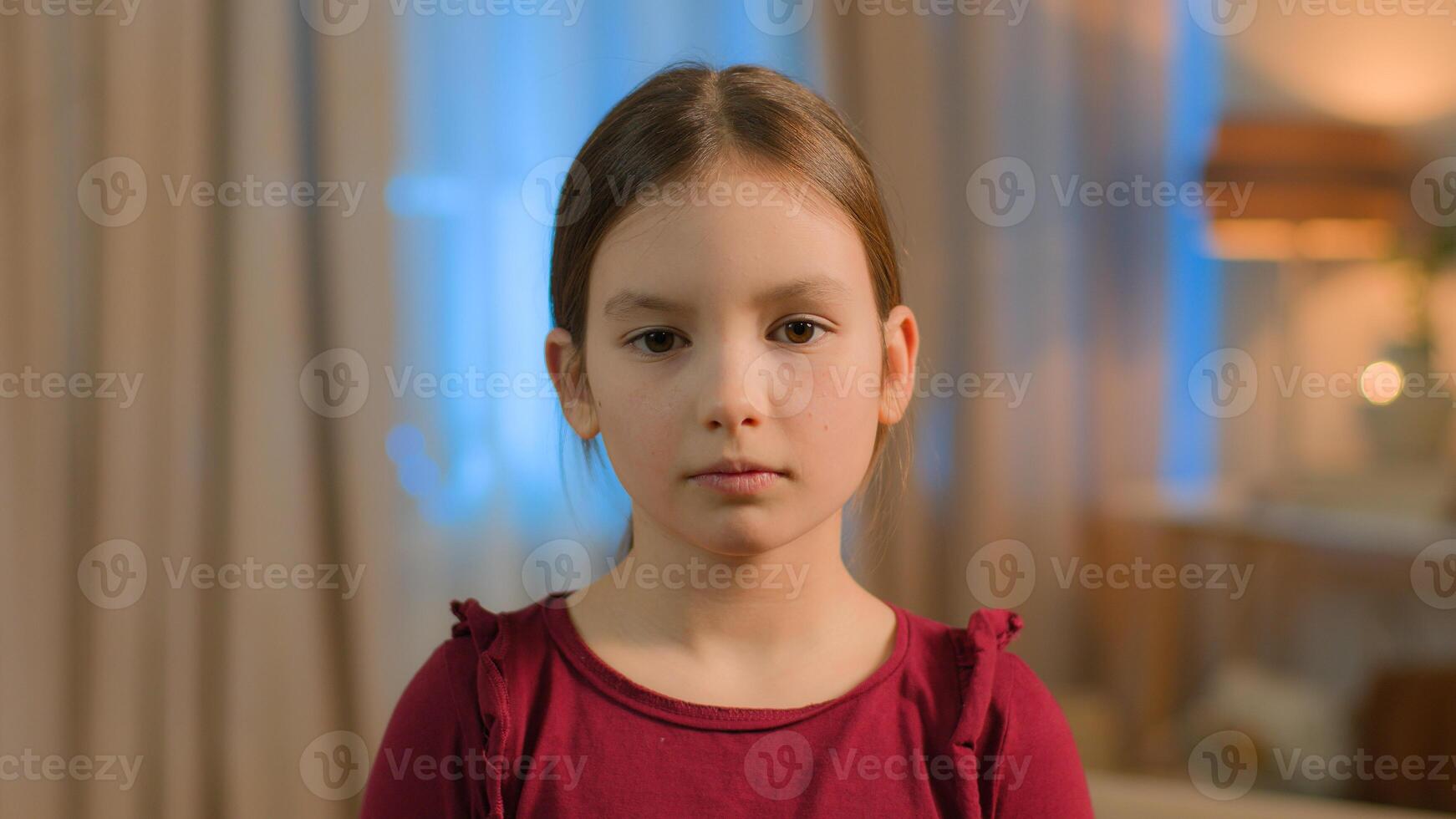 Portrait little girl pensive upset serious Caucasian child kid offended daughter schoolgirl at home school problem sad innocence face abuse offense family custody crisis alone adopted orphan childcare photo