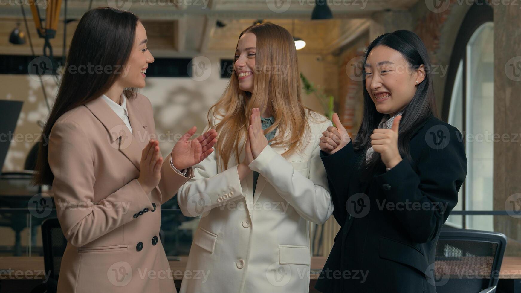 Happy smiling laughing joyful positive friendly business women people colleagues females multiracial multiethnic girls businesswomen diversity Caucasian Asian Korean friends talking in office laugh photo