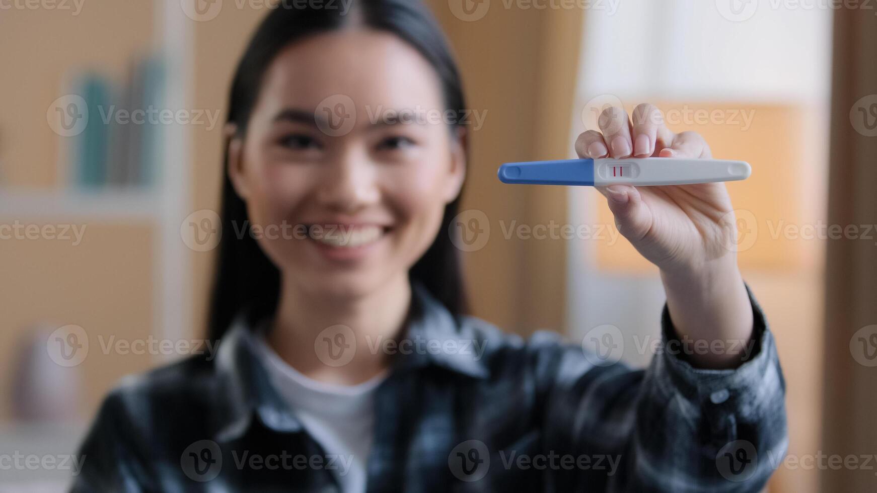Portrait of pregnant woman mother smiling satisfied with artificial insemination procedure medical help shows positive test pregnancy with two stripes in anticipation of childbirth maternity love care photo