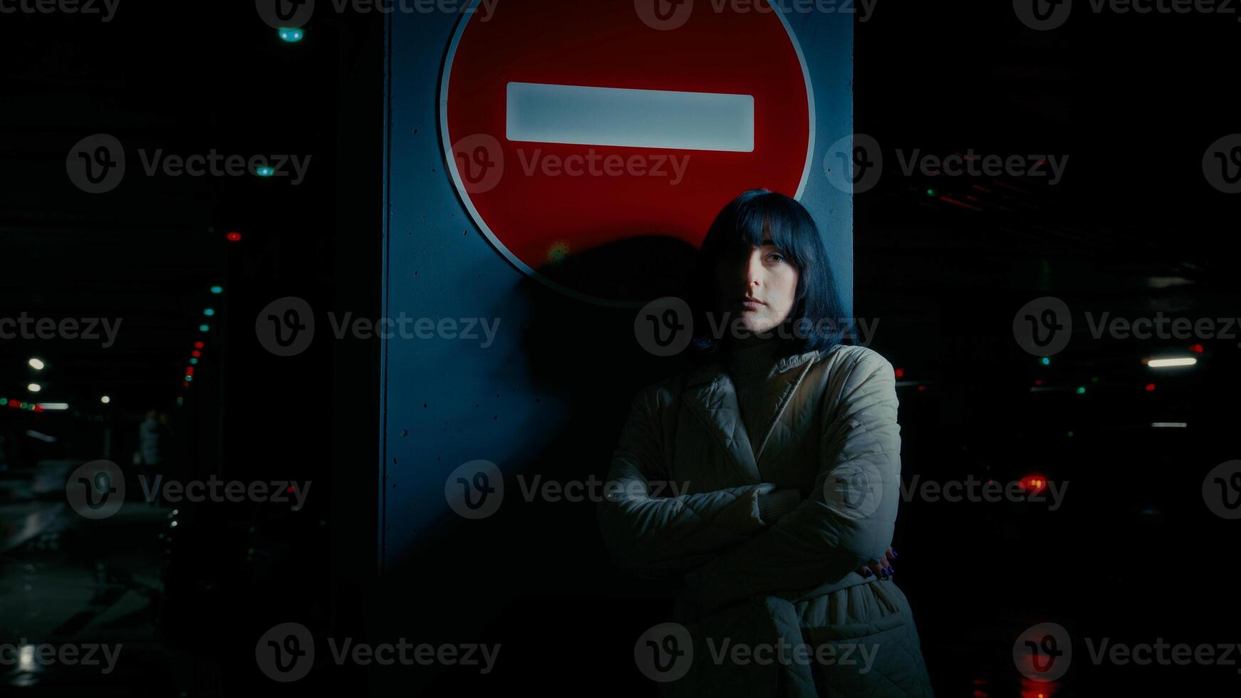 Sad upset stressed anxious depressed woman alone girl female lady standing at dark parking lot at night darkness near stop traffic road sign no drive thinking suffer feel stress depression despair photo