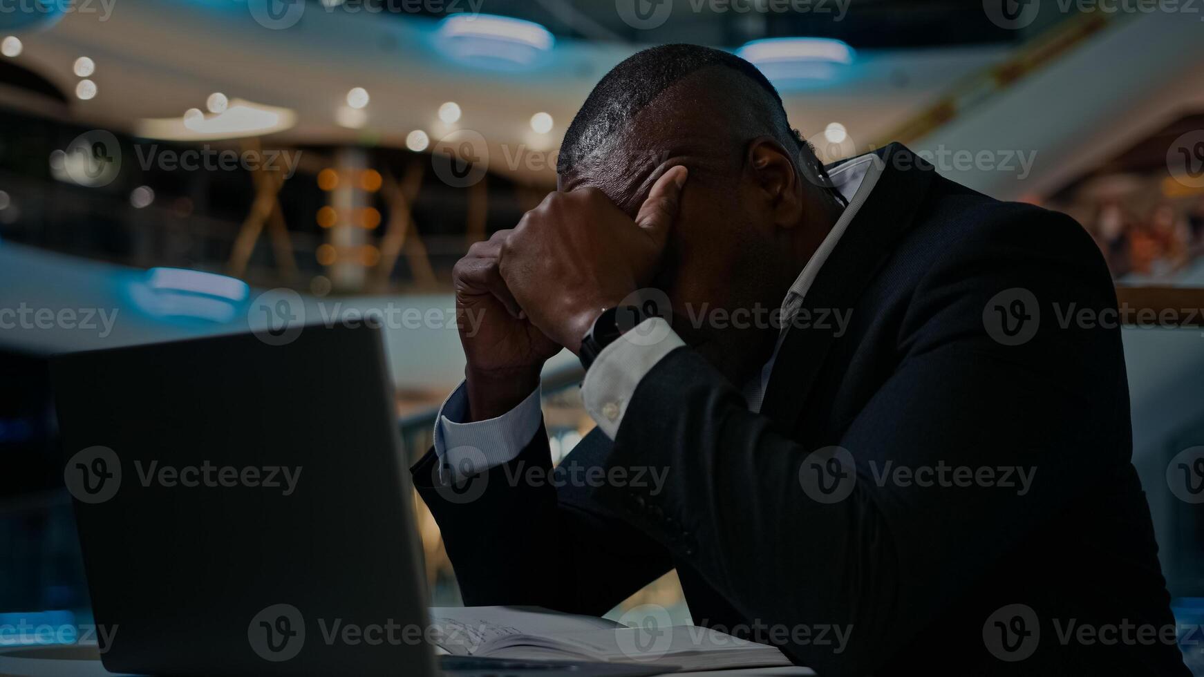 Middle-aged ethnic stressed worried man has problem with business papers error laptop trouble bankrupt male 50s businessman with headache African worker anxious bookkeeper difficult decision despair photo