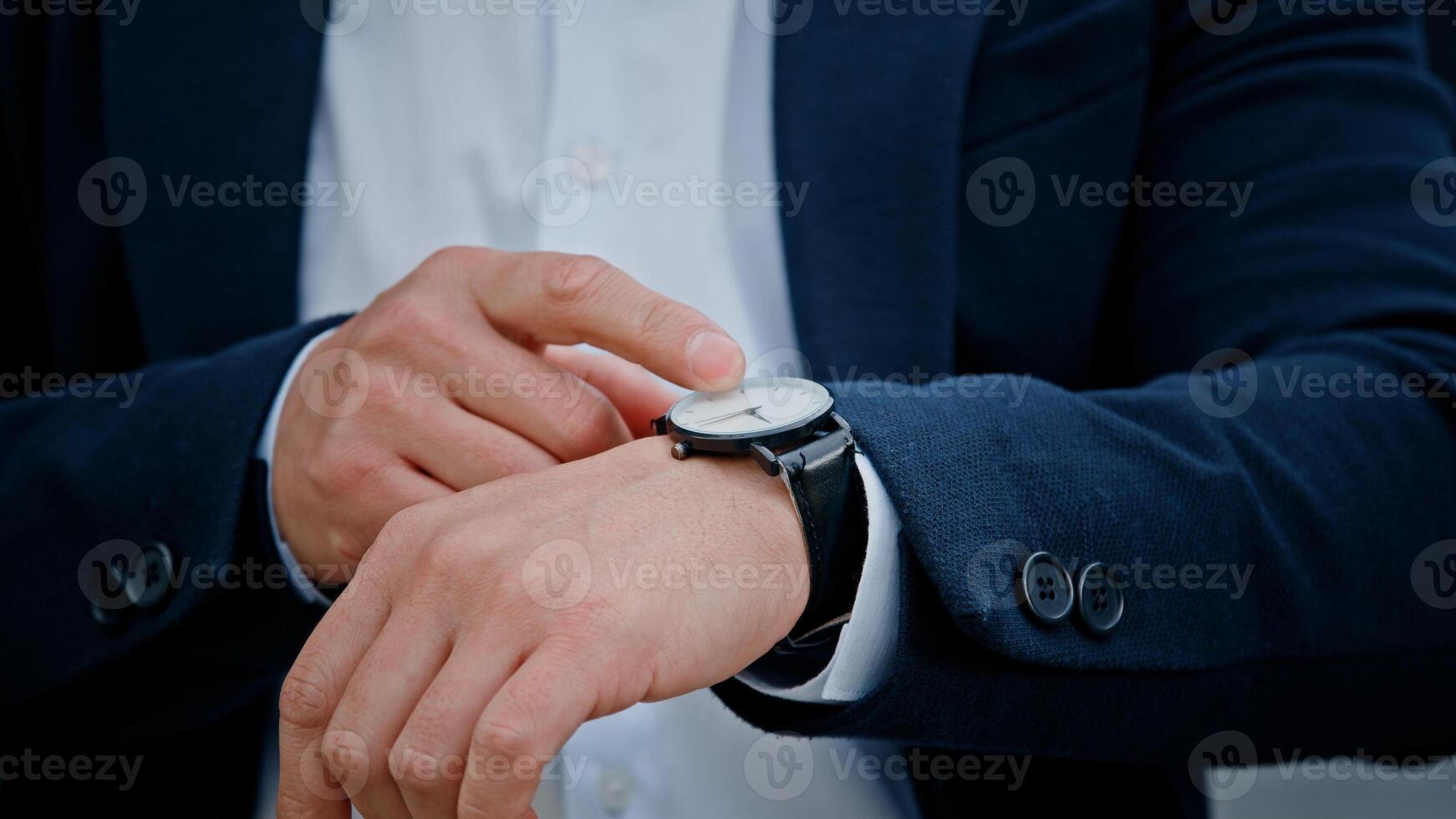 Cropped view closeup male hand with wristwatch clock Asian middle-aged businessman manager man male boss company CEO entrepreneur employer check time lateness waiting for meeting taxi in city outdoors photo