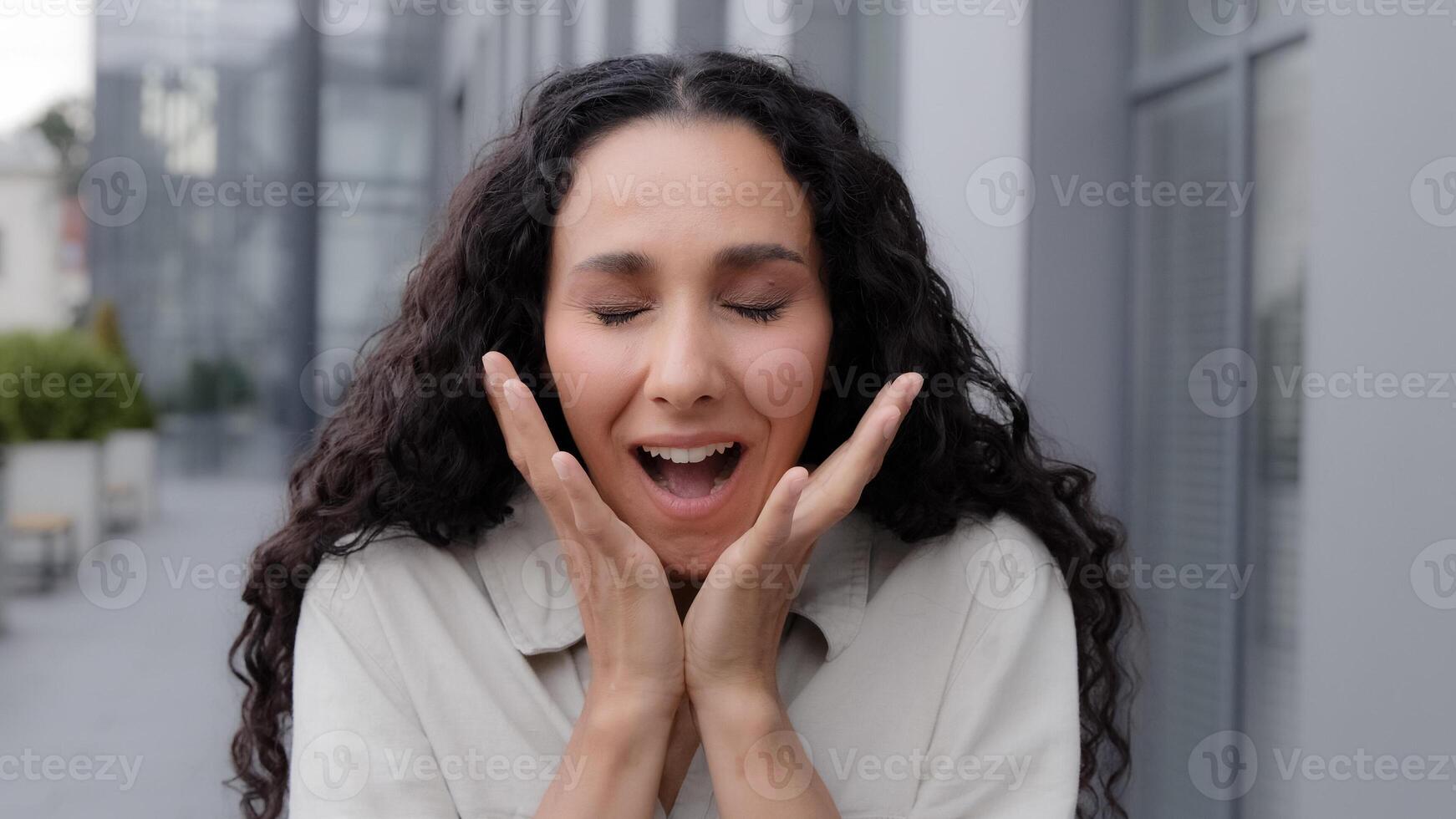 Close up Oh my god wow female facial reaction. Amazed excited shocked wonder Caucasian woman girl raising hands in surprise unbelievable news victory winning looking at camera with big eyes outdoors photo