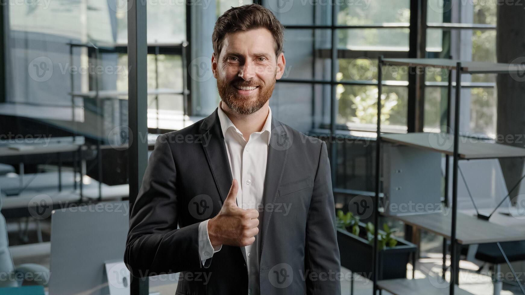 Bearded happy confident bearded Caucasian 40s middle-aged man boss leader trader salesman businessman creative company CEO showing thumb up good idea excellent perfect gesture recommend sign in office photo
