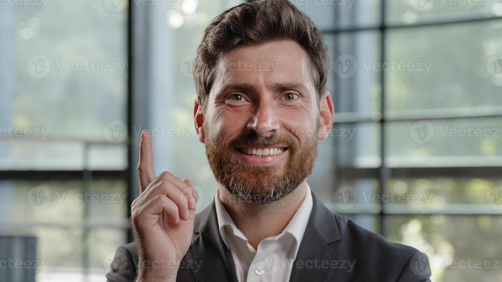 Happy adult Caucasian bearded man 40s businessman posing looks around thinks pondering pensive thoughtful thinking about job project problem solutions comes up with ideas raised finger up in office photo