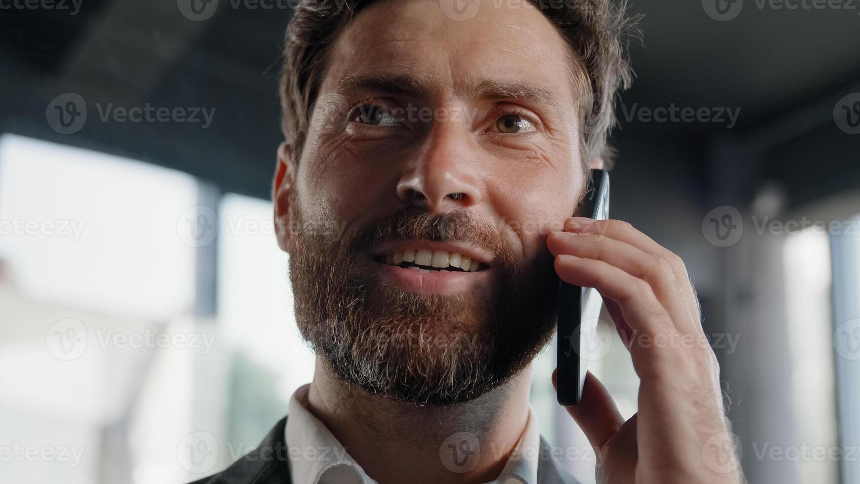 Closeup Caucasian smiling bearded man answer call calling friendly talk virtual consultation boss manager salesman agent 40s businessman talking phone friendly conversation speak to smartphone discuss photo