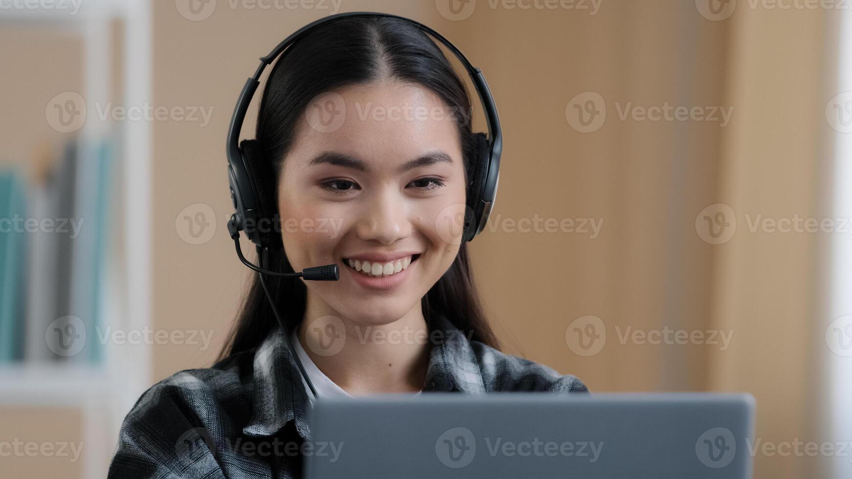 Portrait asian woman student girl online distant teacher wear headset talking conference call speak looking at laptop at home office chat job interview distance language course e-learning class photo