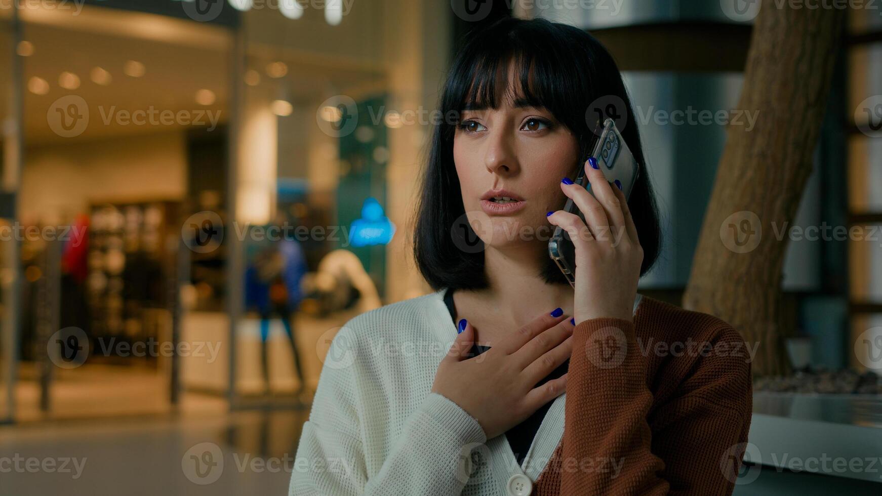 Worried upset shocked woman indoors answer call talking phone disappointed with smartphone conversation business problem lady speaking worry dissatisfied stressed female mobile talk trouble bad news photo