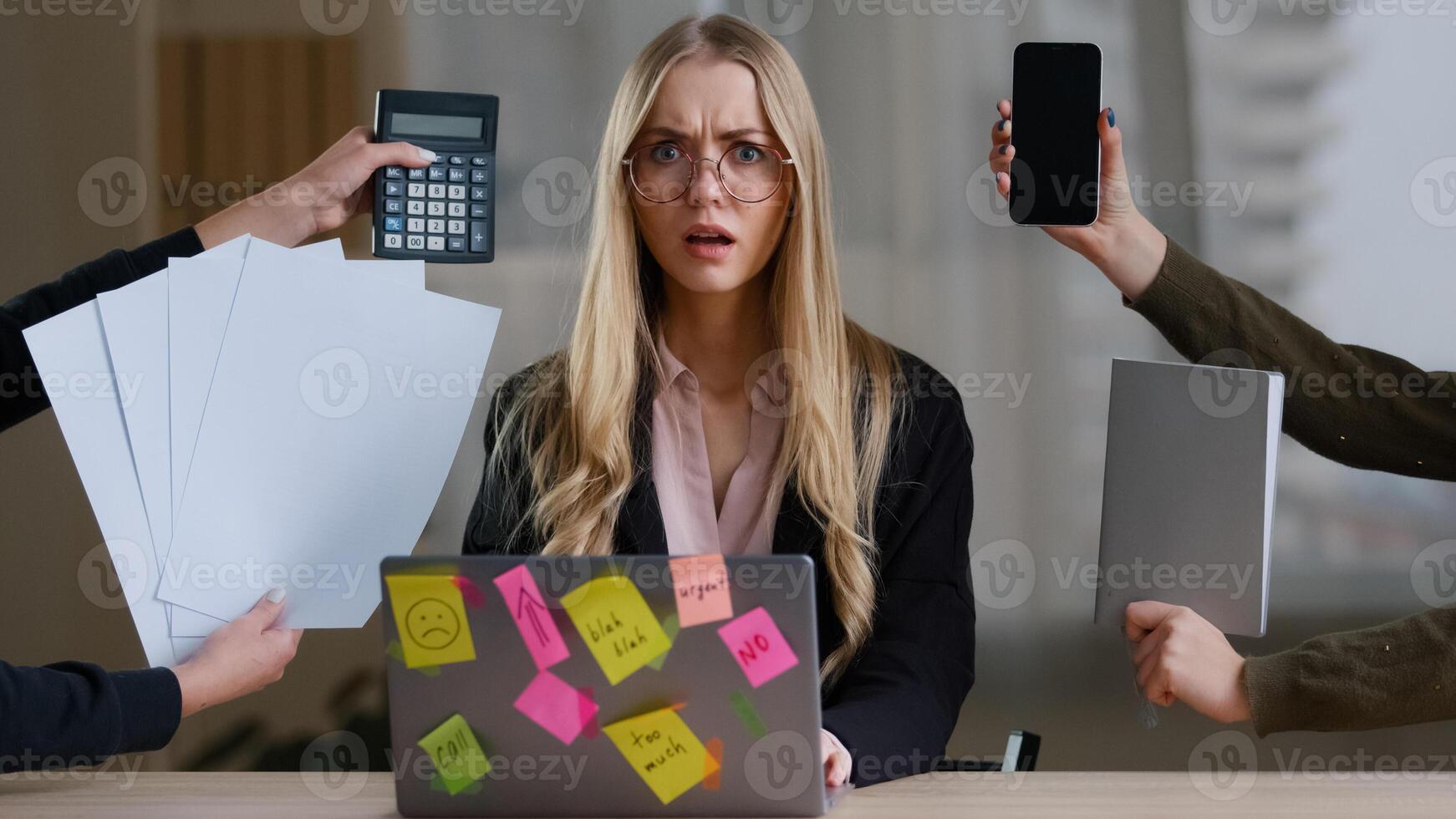 Multitasking business woman manager in office sitting at table have many tasks work feeling stress overworked exhausted from hands with calculator notebook papers phone tired girl in glasses headache photo
