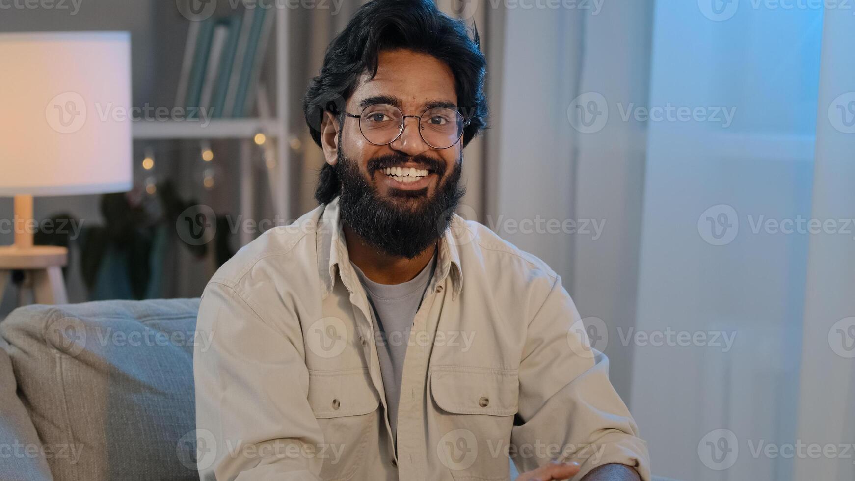 Arabic bearded surprised indian shocked man in glasses at home looking at camera says wow wide opens eyes and mouth in surprise of unexpected news happiness answers yes delight enthusiastic reaction photo