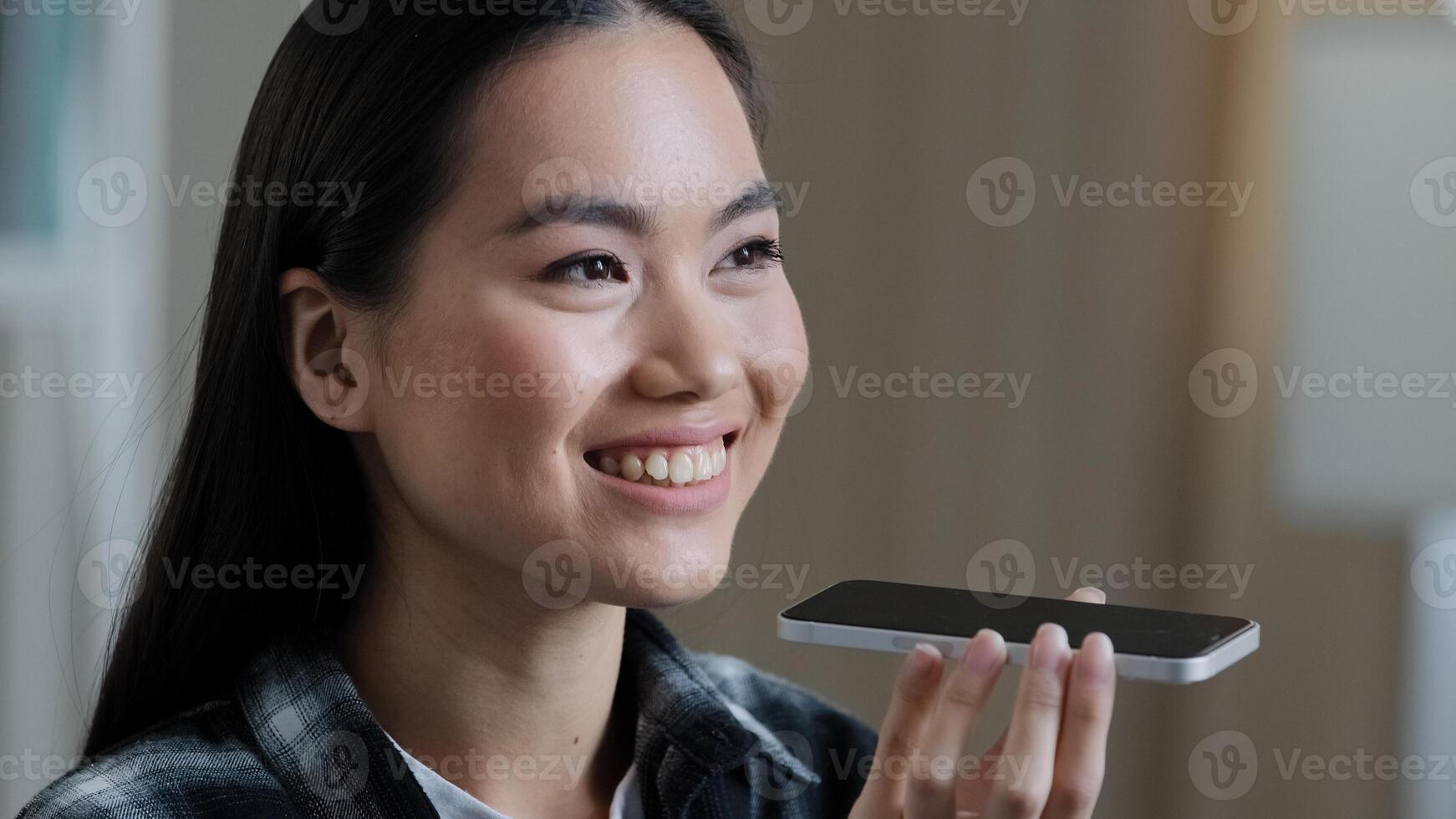Portrait asian korean woman girl recording voice recognition message on speakerphone lady female at home using virtual assistant app sets reminder on phone at home office digital ai mobile assistance photo