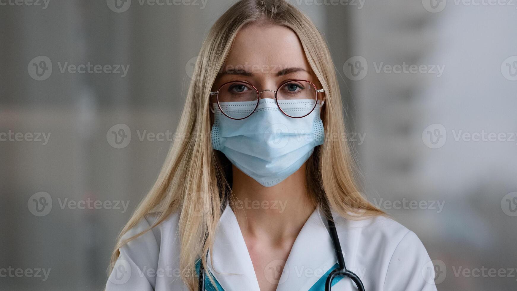 Female doctor in medical mask looking at camera talking angry show index finger no negative gesture mad stressed woman psychologist nurse in white coat office show one with hand aggressive explain photo