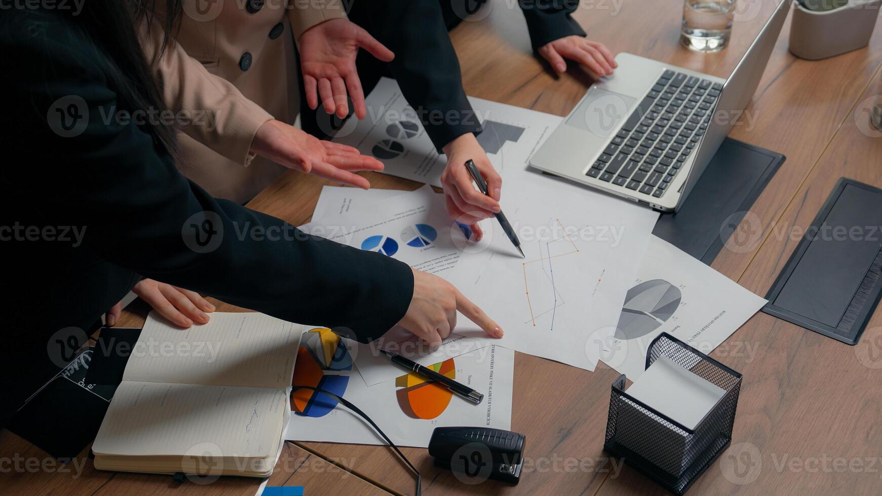 Three talking business women smile girls multiracial female multiethnic businesswomen Asian Caucasian Muslim colleagues happy discuss documents paperwork teamwork celebrate financial growth in office photo