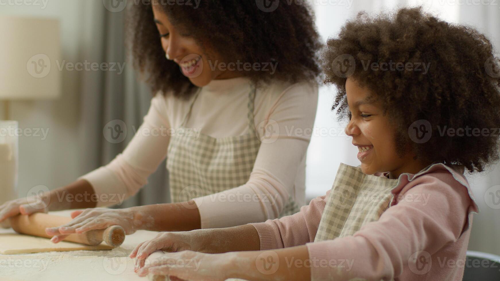 Food delivery eco products flour supermarket happy African American mother teach little daughter child kid girl flattening dough with rolling-pins in kitchen family together cooking pizza pie smiling photo
