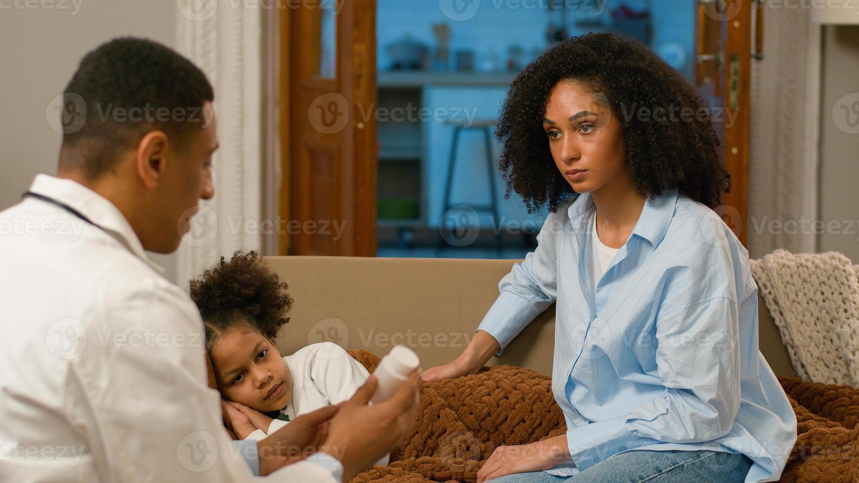 African American doctor paramedic holding out pills medicine drugs pharmacy patient symptoms mother mum parent therapist recipe painkiller pharmaceutical vitamin disease ill medication prescription photo