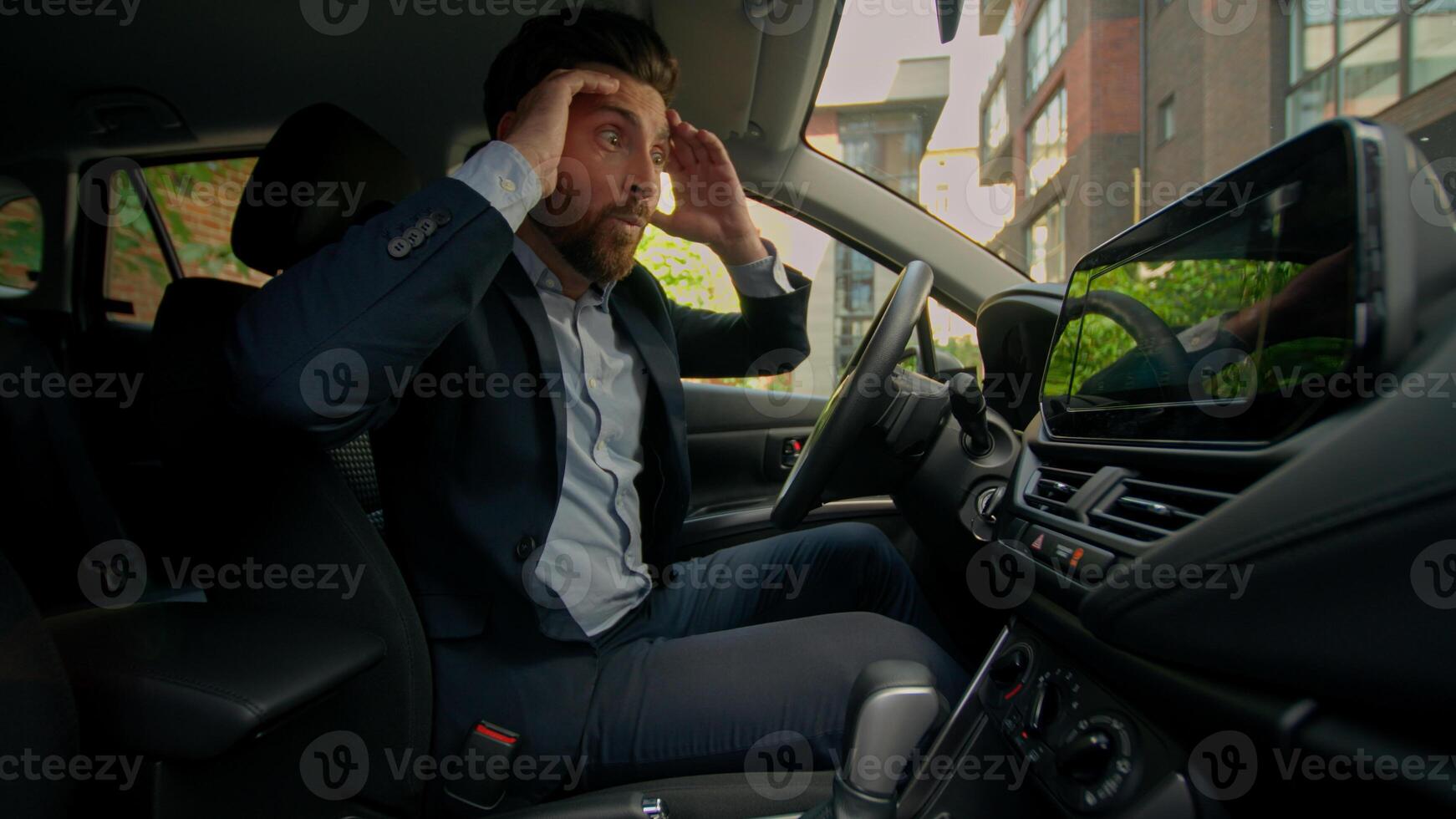 Happy excited Caucasian man inside luxury automobile driver male guy shock businessman buying electric transport rent modern vehicle smiling owner car driving in city purchase credit auto dealership photo