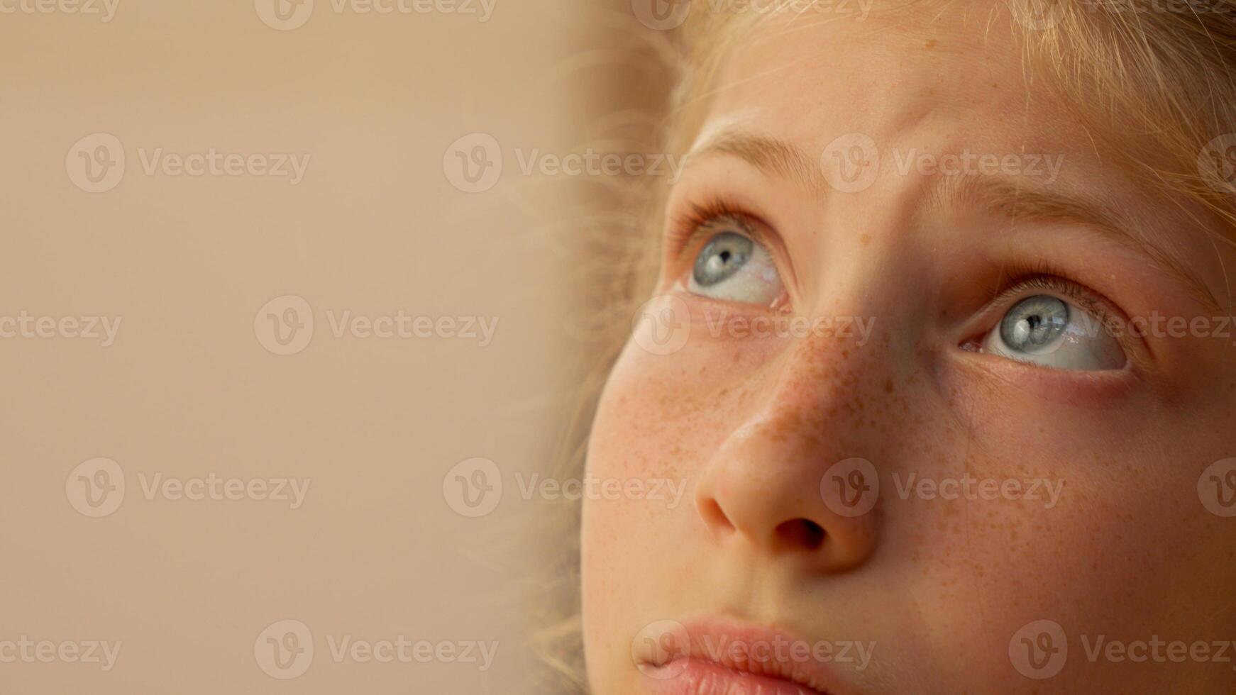 Close up little sad girl with blue eyes worried upset female face child Caucasian kid daughter schoolgirl sport athlete sportswoman gen z teen thinking bad mood offended primary school abuse problem photo