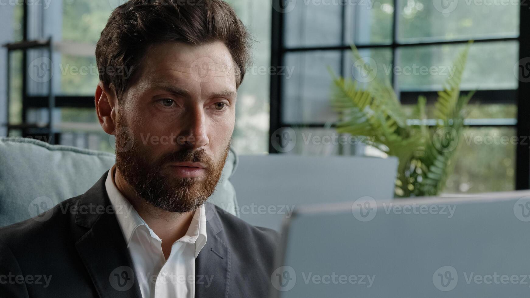 Close up caucasian bearded middle aged 40s freelancer man worker user manager company CEO employee businessman working on computer concentrated entrepreneur developing new project online on laptop app photo