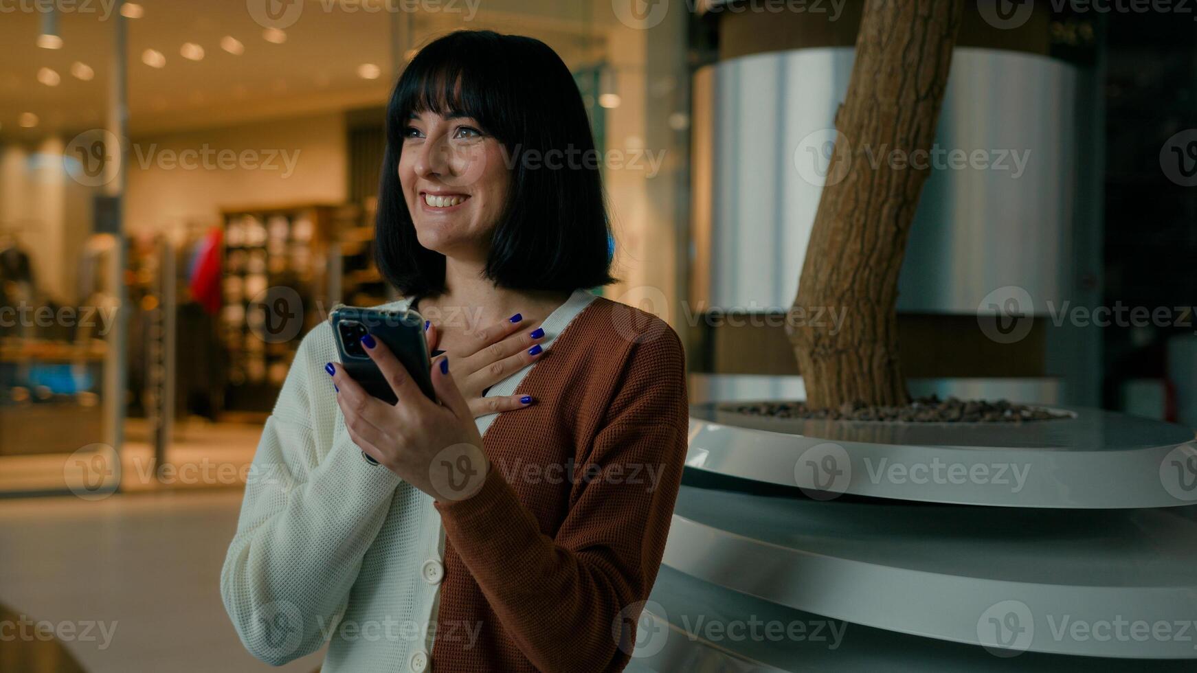 Happy amazed woman female girl win with mobile phone bet browsing, winning celebrating cellphone success triumph chatting communication with smartphone feeling wonder amazement shock victory indoors photo