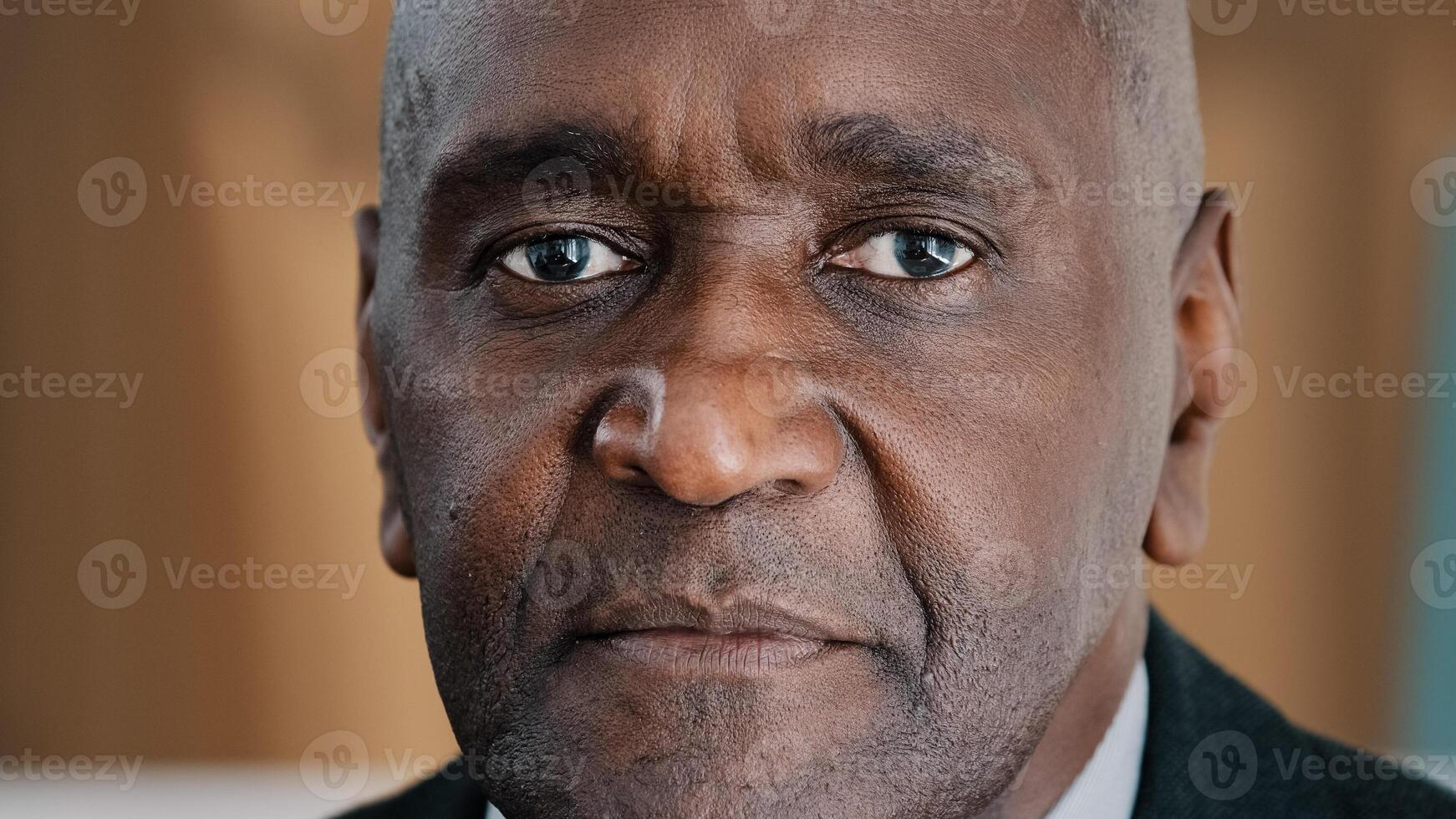 Portrait indoors sad serious mature African man in male face successful middle-aged architect expert boss old elder businessman trader leader manager alone pensive 50s person looking at camera closeup photo