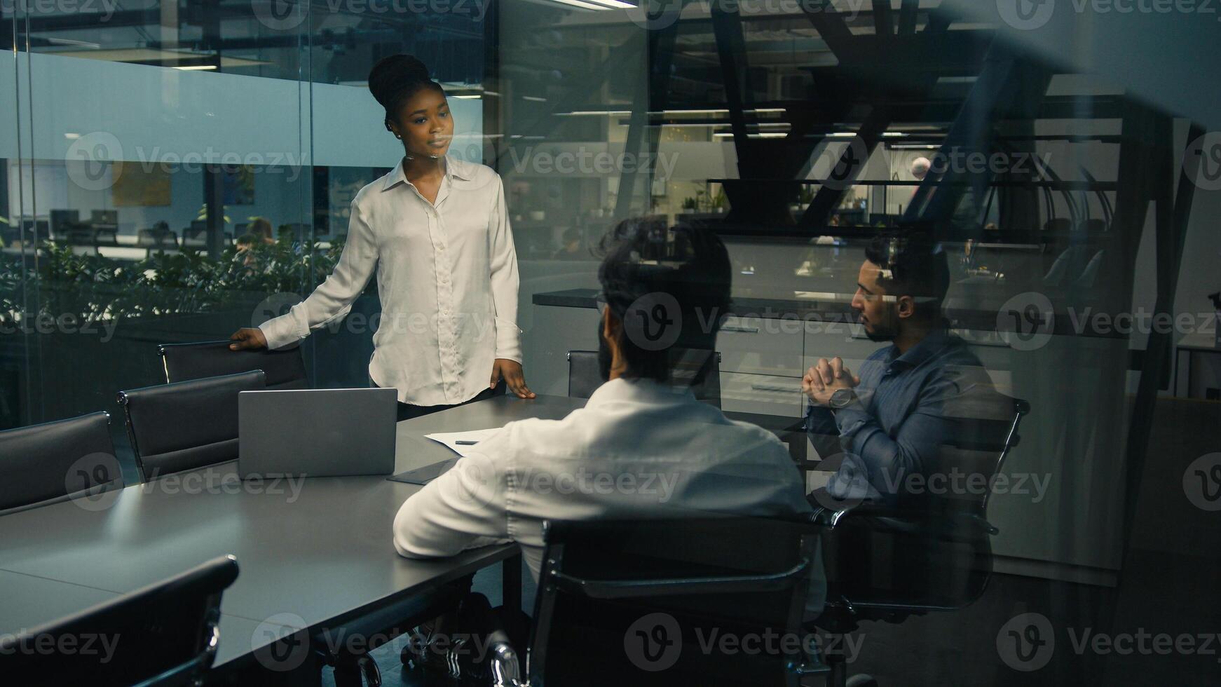 African American businesswoman leader woman female coach business trainer CEO leader boss talking to multiracial business team multiethnic diverse group of workers in office brainstorming teamwork photo