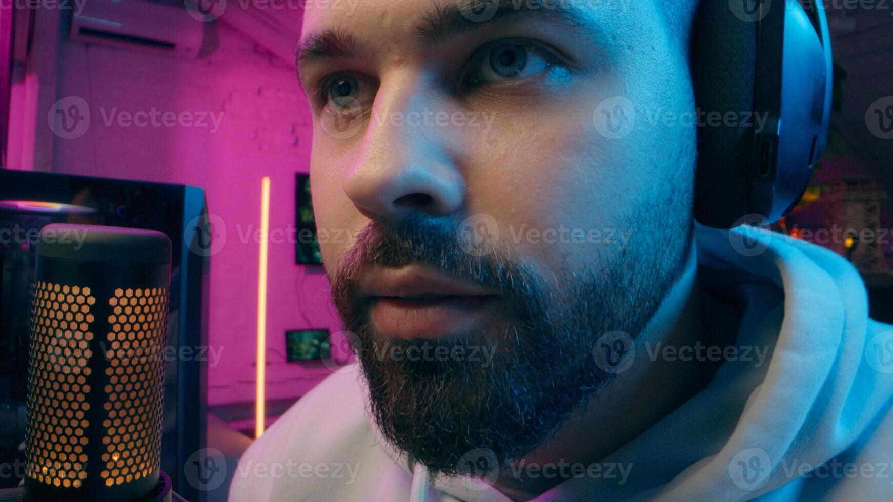 Astonished shocked Caucasian vlogger guy male laugh blogger influencer close up surprised man gaming addicted male streamer play cyber sport online game pc computer neon amazement wow emotion at home photo