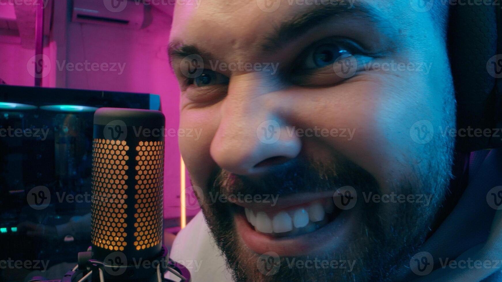 Astonished shocked Caucasian vlogger guy male laugh blogger influencer close up surprised man gaming addicted male streamer play cyber sport online game pc computer neon amazement wow emotion at home photo