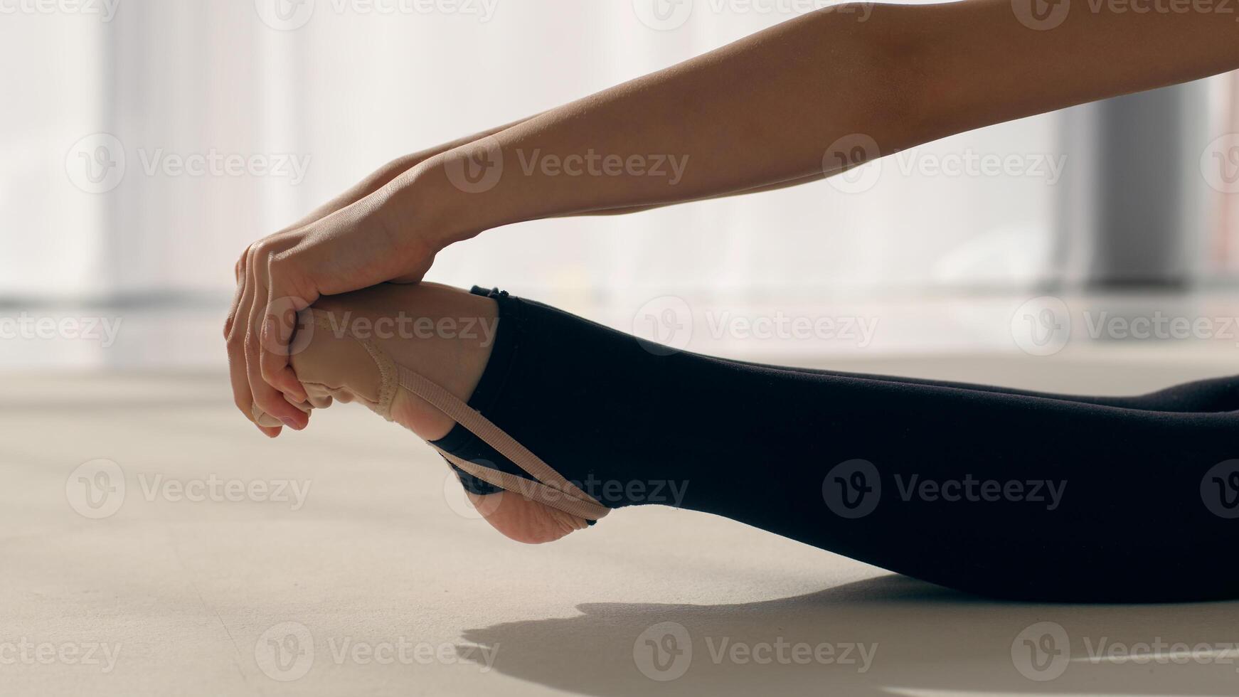 Little sportswoman young teen girl female gymnast ballerina dancer child daughter kid schoolgirl exercise training in gym bending stretching legs flexible feet sport gymnastics ballet dance workout photo