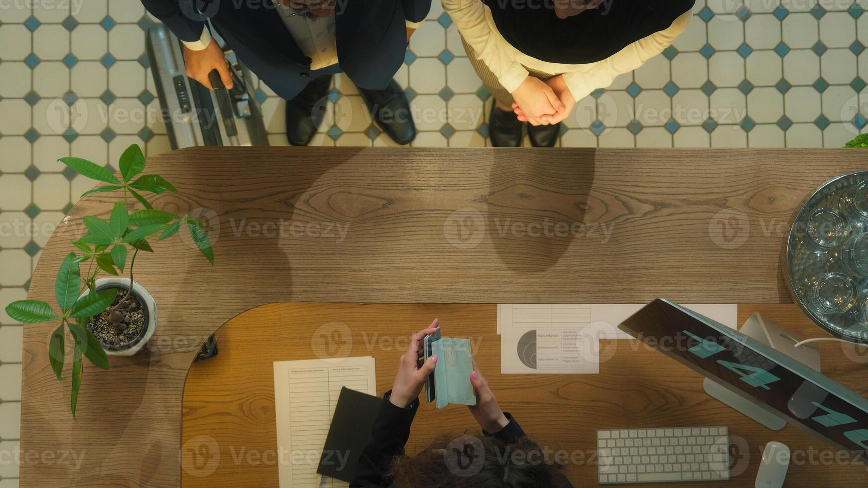 Top view concierge meet guests welcome hotel reception muslim couple tourists travelers arrive resort journey vacation travel abroad administrator check passports give key card booking room service photo