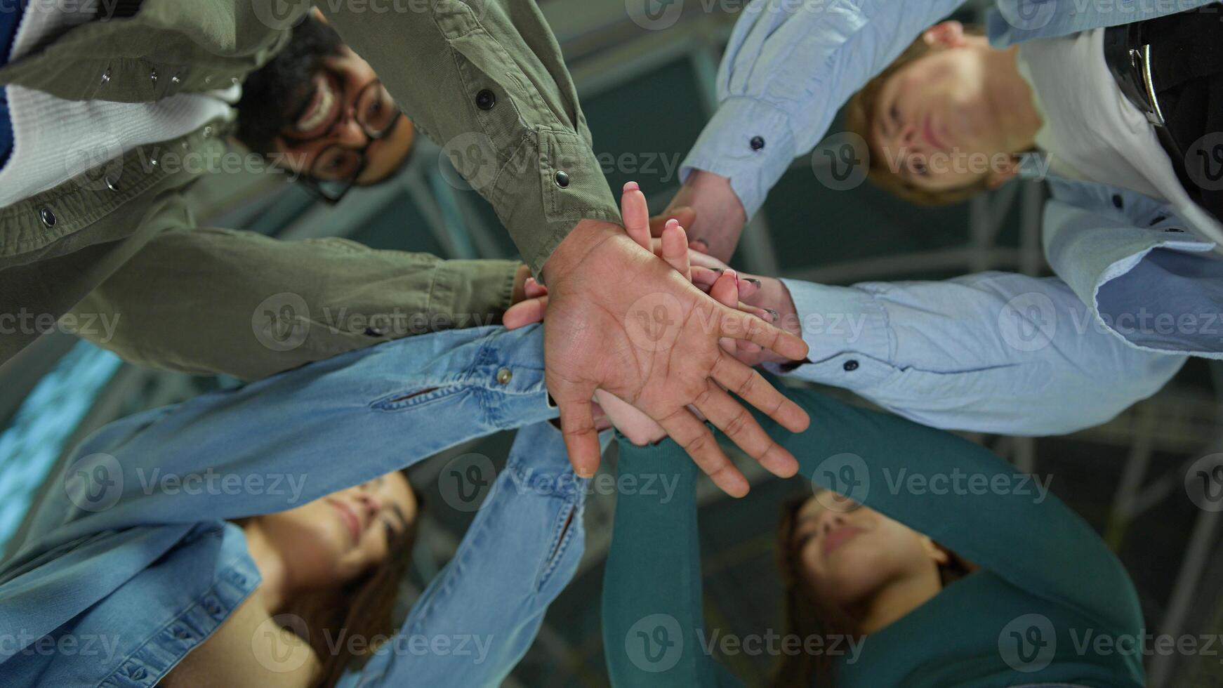 Happy business women men multiracial friends students group corporate colleagues stacking hands in pile join team gesture unity teamwork support girls guys male female put arms together bottom view photo