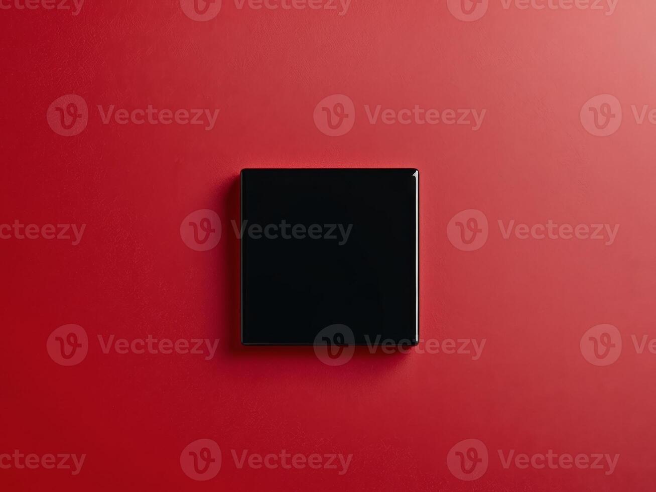 Black Square Object on Vibrant Red Background for Dynamic Visuals photo