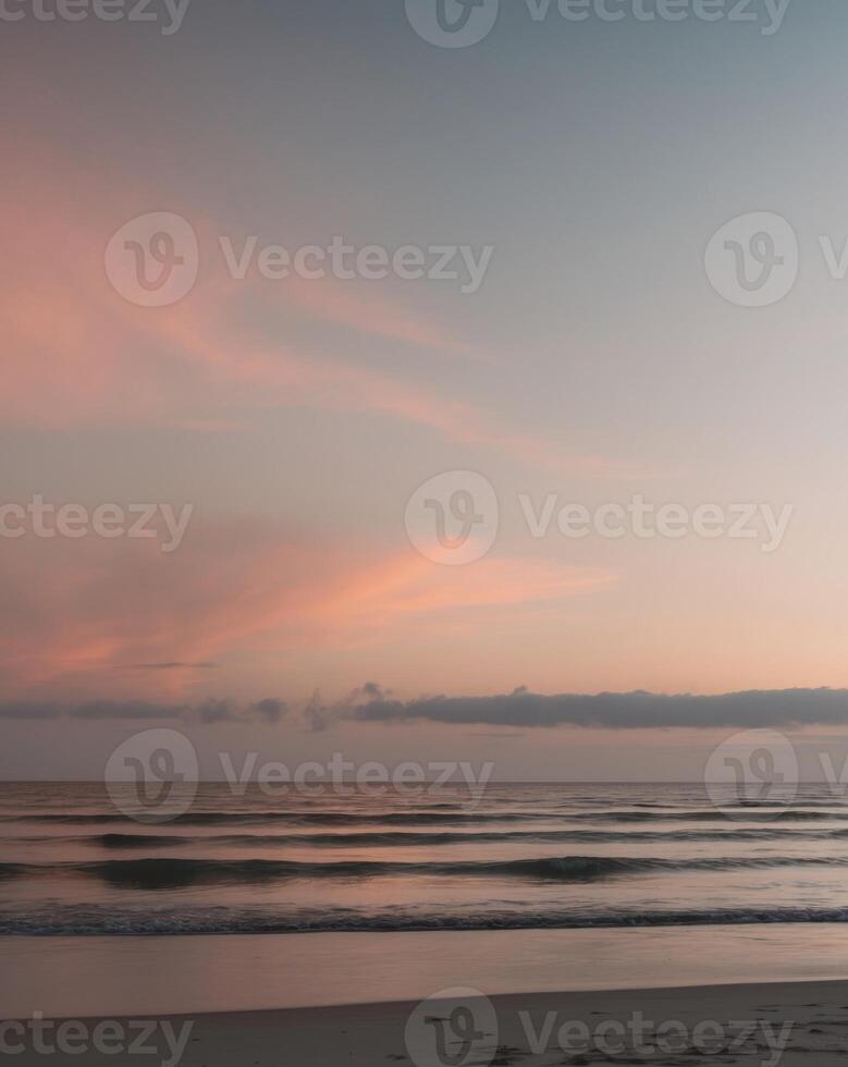 A peaceful sunset scene with ocean waves and sky colors photo