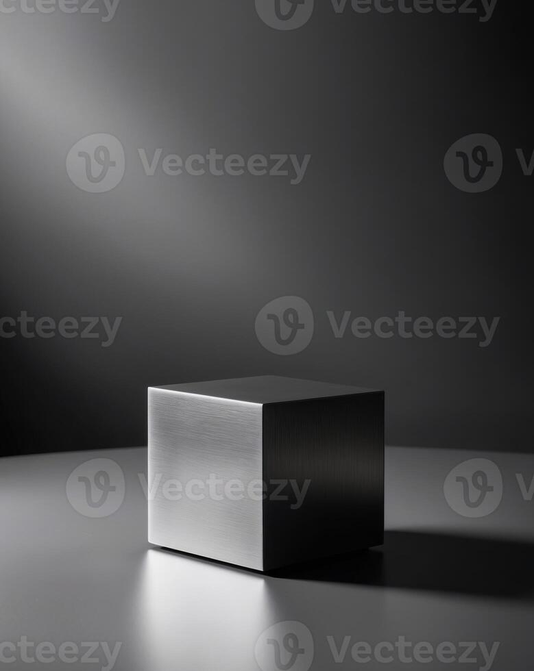 A black cube sitting on a table in front of a dark background photo