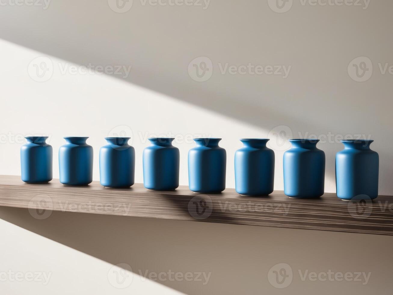 A row of blue vases sitting on top of a shelf photo