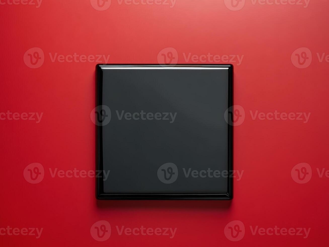 Black Square Object on Vibrant Red Background for Dynamic Visuals photo