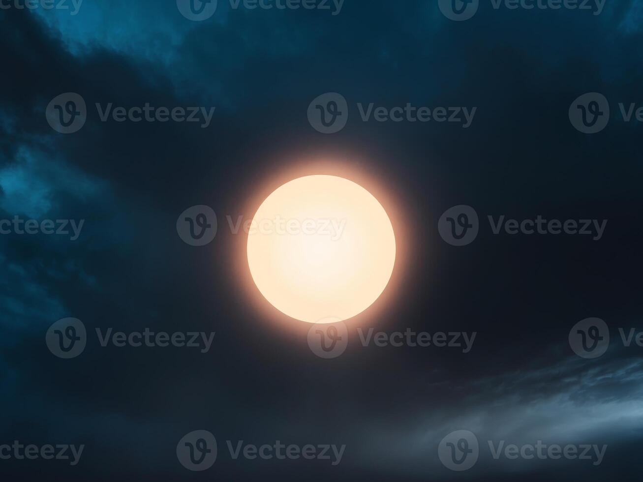 A dark sky with a glowing circle in the middle photo